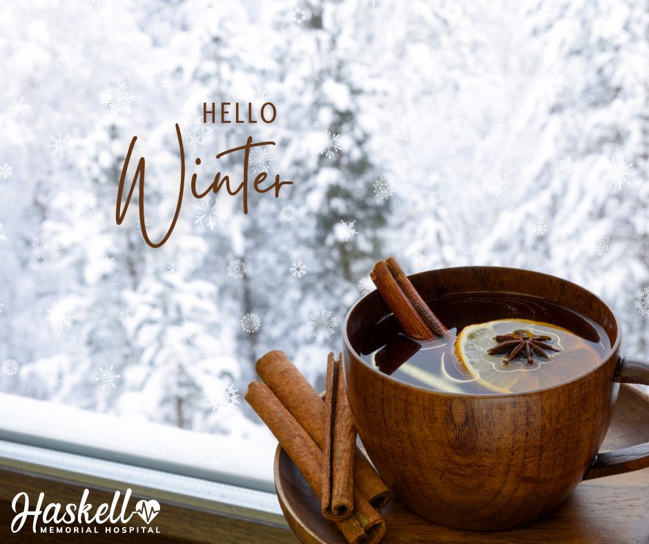 This photo depicts a winter scene with a mug of hot cider and the slogan "Hello Winter" with the Haskell Memorial Hospital logo