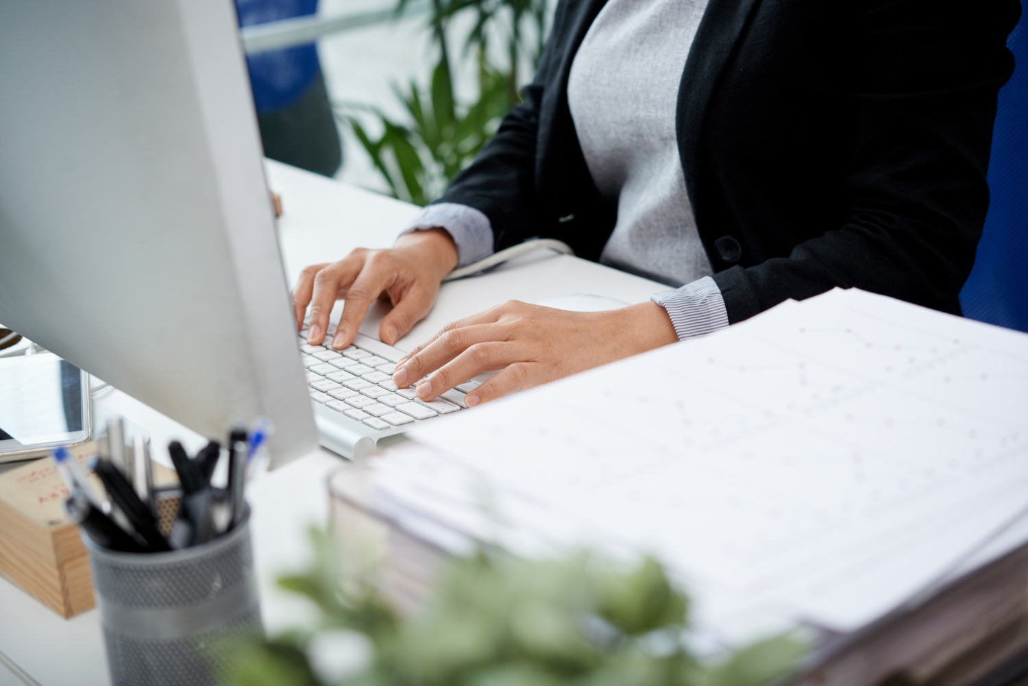 woman working on billing at a desk in the business office at Haskell Memorial Hospital